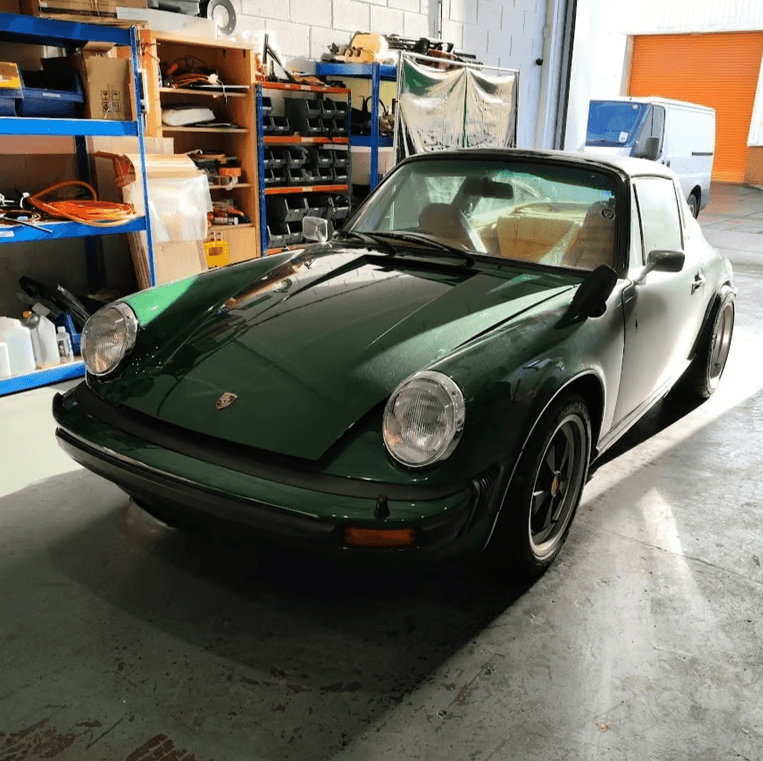 Porsche 911 EV conversion undergoing high-voltage isolation fault diagnosis and battery inspection
